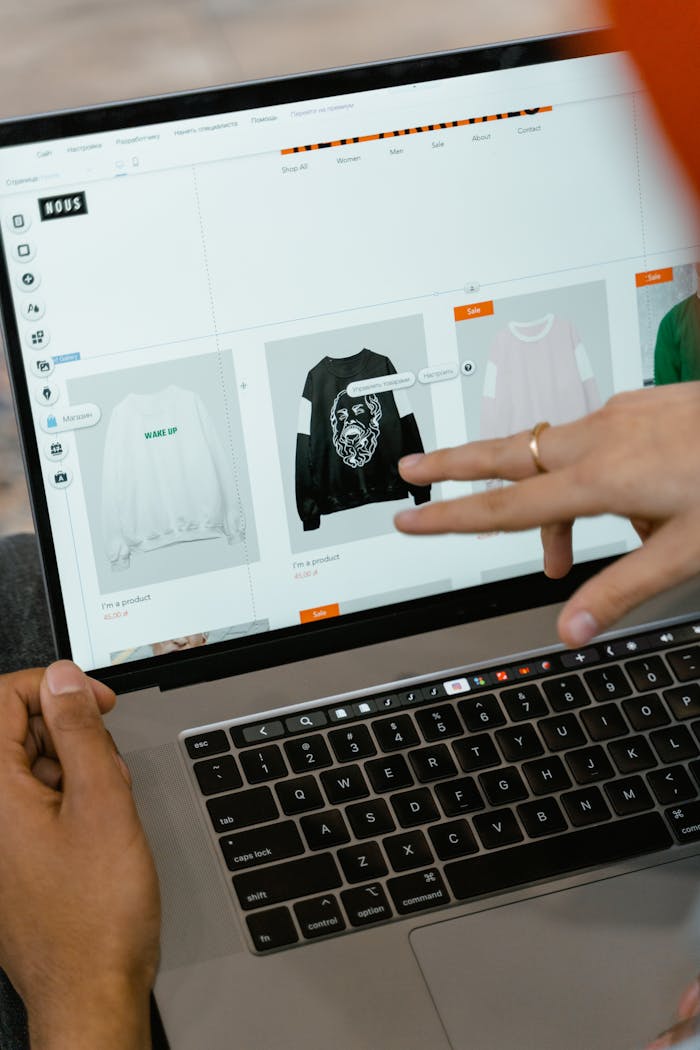 Home Close-up of hands interacting with a shopping website on a laptop screen indoors.